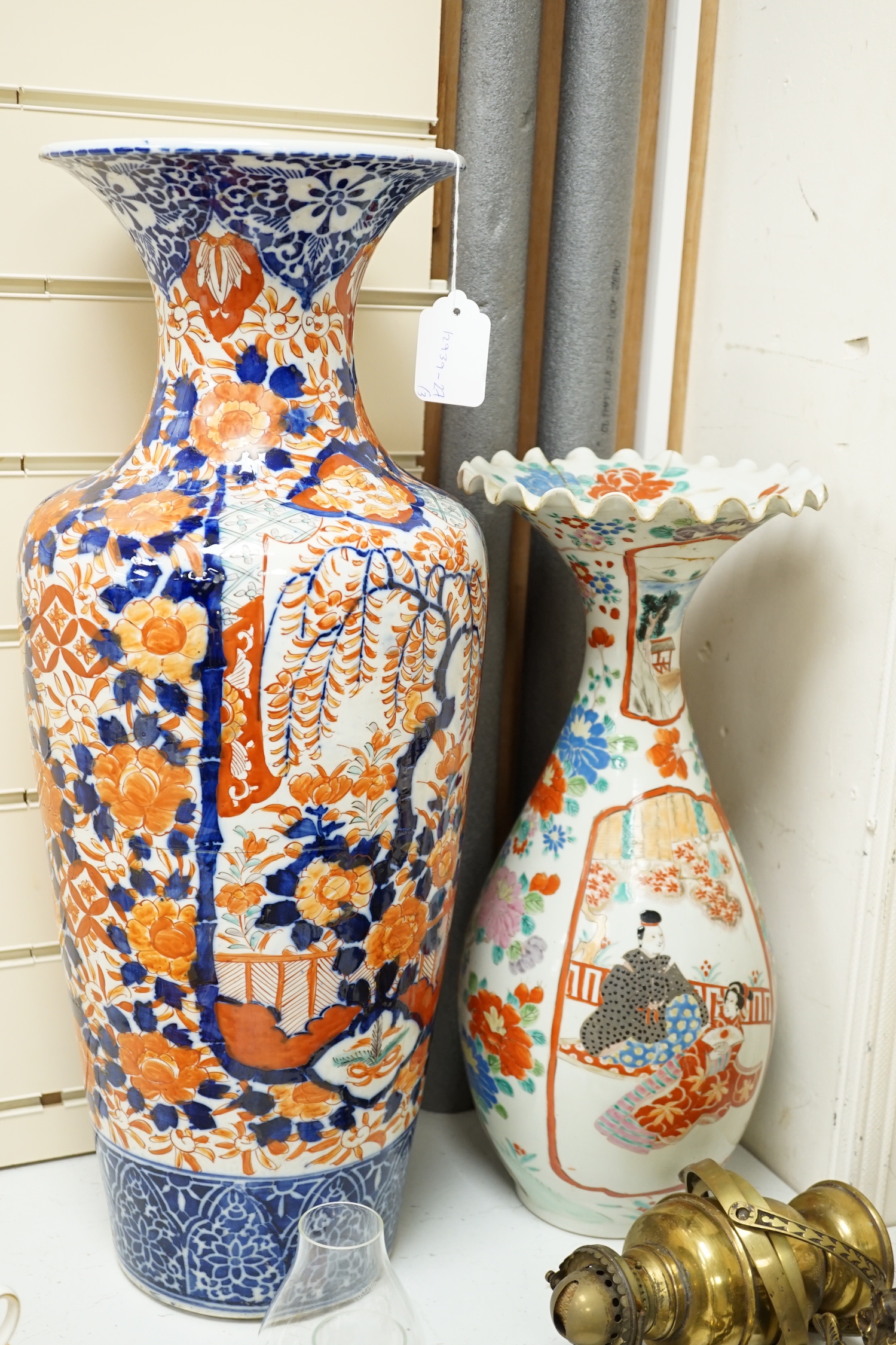 A large Japanese Imari vase together with a pair of flared top Imari vases, largest 62cm high